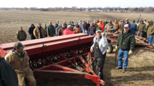 People at an auction with farm equipment